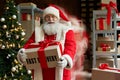 Happy Santa in blur motion holding present, fast xmas delivery, Christmas rush.