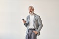 Smiling old senior business man using mobile phone standing isolated on white. Royalty Free Stock Photo