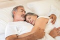 Happy old caucasian husband hugging his wife in bed, enjoy good morning together, cozy, lazy Royalty Free Stock Photo