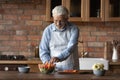 Happy old Caucasian man cooking food at home Royalty Free Stock Photo