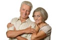 Happy old couple embracing on a white background