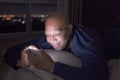 Happy old elderly black man. African American people using a smartphone on social media internet and sleeping on bed in bedroom at Royalty Free Stock Photo