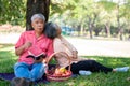 Happy old elderly couple spouses relaxing and sitting on a blanket in the park and sharing few precious memories. Senior couple Royalty Free Stock Photo