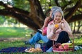 Happy old elderly couple spouses relaxing and sitting on a blanket in the park and sharing few precious memories. Senior couple Royalty Free Stock Photo