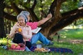 Happy old elderly couple spouses relaxing and sitting on a blanket in the park and sharing few precious memories. Senior couple Royalty Free Stock Photo