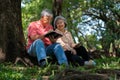 Happy old elderly couple spouses relaxing and sitting on a blanket in the park and sharing few precious memories. Senior couple Royalty Free Stock Photo