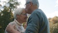 Happy old enjoying day in park. Senior man flirting with elderly woman. Dance in autumn day Royalty Free Stock Photo