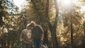 Happy old enjoying day in park. Senior man flirting with elderly woman. Dance in autumn day Royalty Free Stock Photo