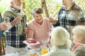 Old lady treats her cake to a friend during a garden party