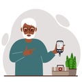 Happy old man holds a glucometer in his hand. The concept of blood sugar control, diabetic.