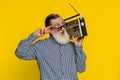 Happy old man listen music on retro tape record player, disco dancing, fan of vintage technologies Royalty Free Stock Photo