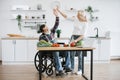 Happy old married man in wheelchair and wife prepare healthy salad. Royalty Free Stock Photo