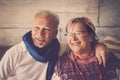 Happy old mature couple have fun at home in smiling portrait - elderly lifestyle man and woman sitting together on the sofa Royalty Free Stock Photo