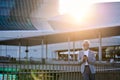 Happy old senior business man using mobile phone standing in city outdoors. Royalty Free Stock Photo