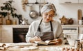 Happy old woman Granny cooks in kitchen kneads dough, bakes cookies