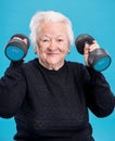 Happy old woman making fitness training with dumbbells Royalty Free Stock Photo