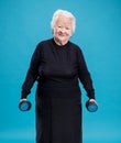 Happy old woman making fitness training with dumbbells Royalty Free Stock Photo