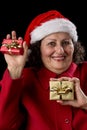 Happy Old Woman with Santa Hat and Two Xmas Gifts