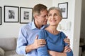 Happy older couple hugging, bonding, looking away dreaming of good future. Royalty Free Stock Photo