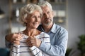 Happy older couple hugging, dreaming about good future together