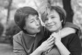 Happy older mother and mature daughter outdoor, black and white portrait