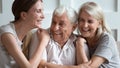 Happy older parents with adult daughter hugging, having fun Royalty Free Stock Photo