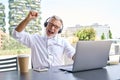 Happy older senior business man using laptop celebrating result winning online. Royalty Free Stock Photo