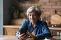 Happy older senior woman using smartphone apps. Royalty Free Stock Photo