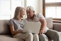 Happy older wife and husband using laptop together, having fun Royalty Free Stock Photo