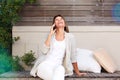 Happy older woman relaxing outside and talking on mobile phone Royalty Free Stock Photo