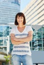 Happy older woman standing in city with arms crossed Royalty Free Stock Photo