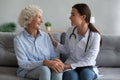 Happy older woman talking with friendly doctor during visit