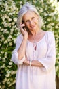 Happy older woman talking on mobile phone Royalty Free Stock Photo