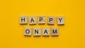 Happy Onam Festival, minimalistic banner with the inscription in wooden letters