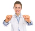 Happy ophthalmologist doctor woman giving glasses