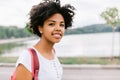 Happy oung african american student female smiling and getting ready to go to college, walking in the park. Beautiful afro Royalty Free Stock Photo