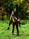 Happy ouple in autumn park. Young family has fun outdoors Royalty Free Stock Photo