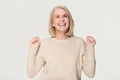 Happy overjoyed middle aged woman celebrating win isolated on background Royalty Free Stock Photo