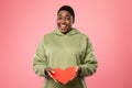 Happy Oversized African Lady Showing Red Paper Heart, Studio Shot