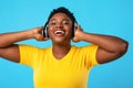 Happy Oversized Black Lady In Headphones Listening Music In Studio