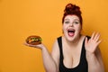 Happy overweight fat woman happy hold big burger cheeseburger sandwich. Girl on diet dieting. Healthy eating fast food concept