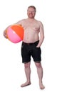 Happy overweight middle aged man with beach ball