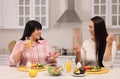 Happy overweight women having healthy meal together at table in kitchen Royalty Free Stock Photo