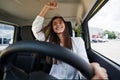 Happy owner. Front view of woman that drives modern new car in the city Royalty Free Stock Photo