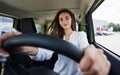 Happy owner. Front view of woman that drives modern new car in the city Royalty Free Stock Photo