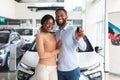 Happy Owners. Cheerful Black Spouses Holding Key Of Their New Car