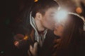 Happy pair loving each other in night park filtered photo with flash flare Royalty Free Stock Photo