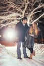 Happy pair loving each other in night park filtered photo with flash flare Royalty Free Stock Photo