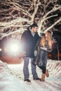 Happy pair loving each other in night park filtered photo with flash flare Royalty Free Stock Photo