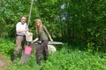 Happy pair at a well, pours water in a bucket